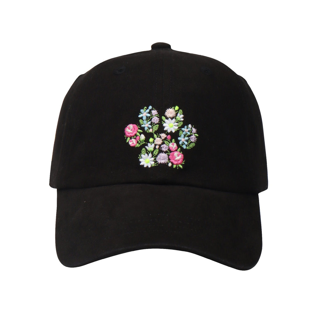 May include: A black baseball cap with a floral embroidery design on the front. The embroidery features pink, blue, and white flowers.