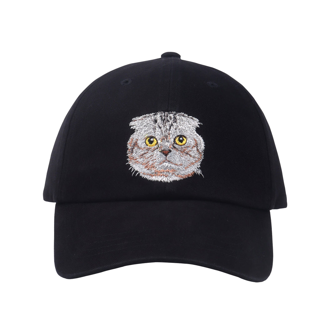 May include: A black baseball cap with a gray and white embroidered cat face on the front.