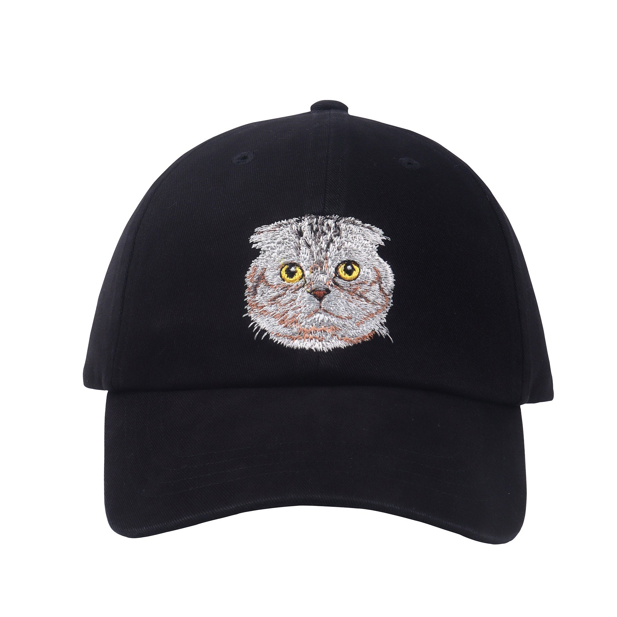 May include: A black baseball cap with a gray and white embroidered cat face on the front.